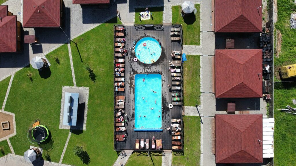 aerial shot of pool and hot tub in neighborhood