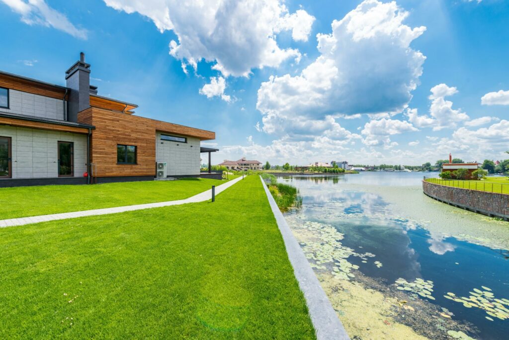 House sits on lawn backing up to retention pond